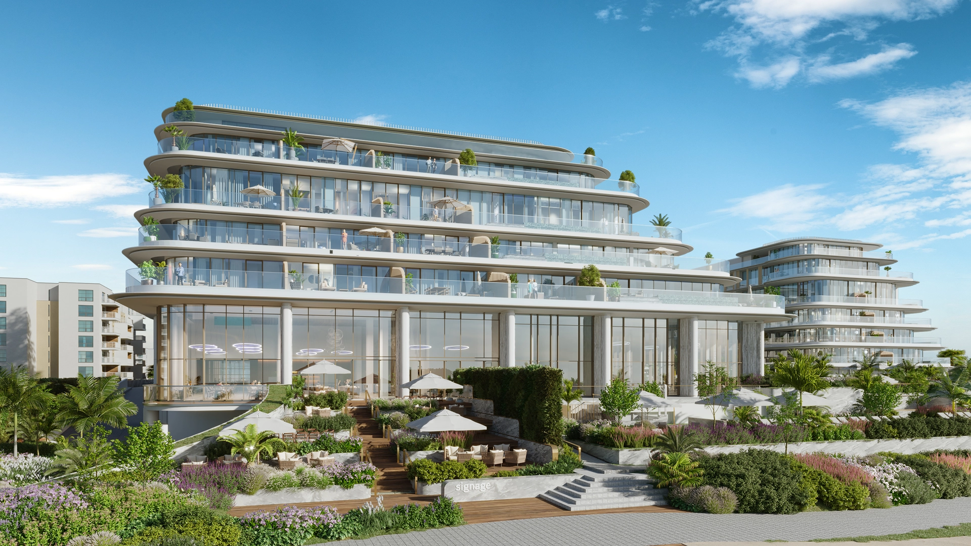 Contemporary low-rise coastal development with layered glazed façades and landscaped terraces